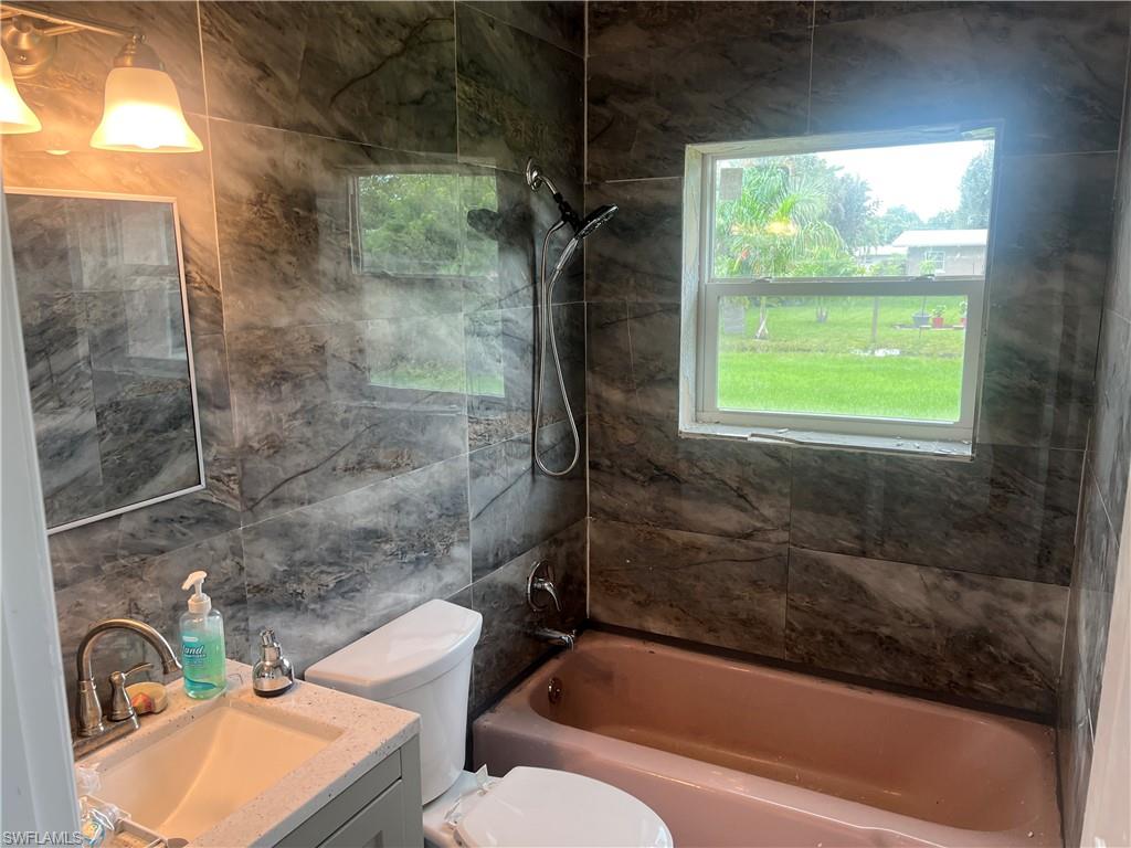 160 Brooks Road North Fort Myers, FL 33917 - Photo 17 of 19 a bathroom with a toilet and a bathtub