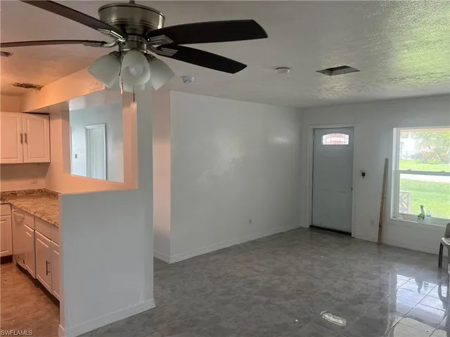a view of a kitchen with a sink and a window