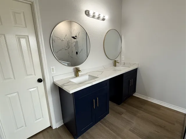 a bathroom with a double vanity sink and a mirror