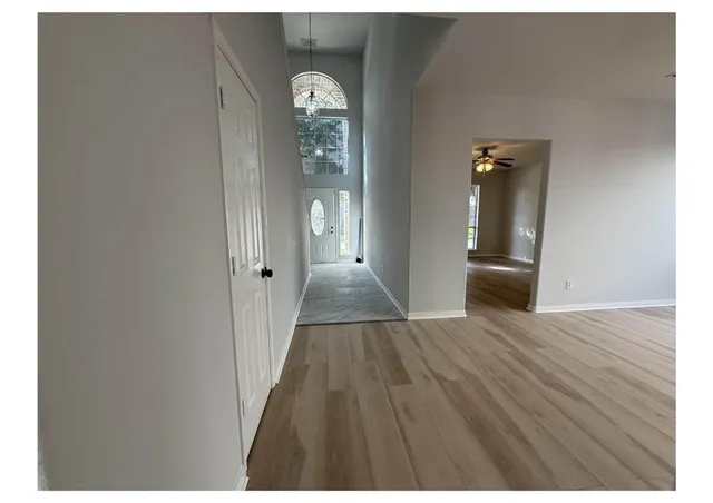 a view of a room with wooden floor and entryway