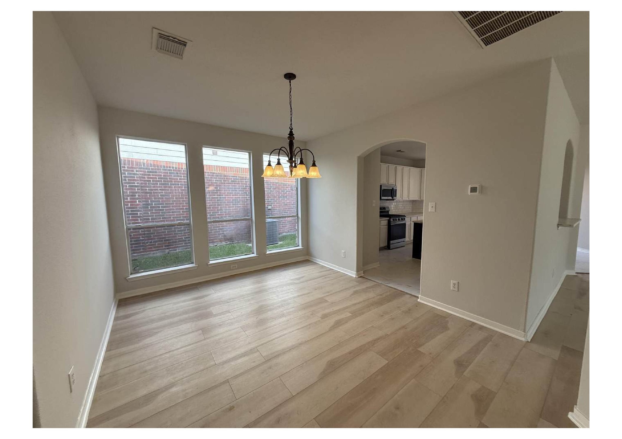 4106 Forest Rain Lane Atascocita, TX 77346 - Photo 21 of 49 a view of an empty room with window and wooden floor