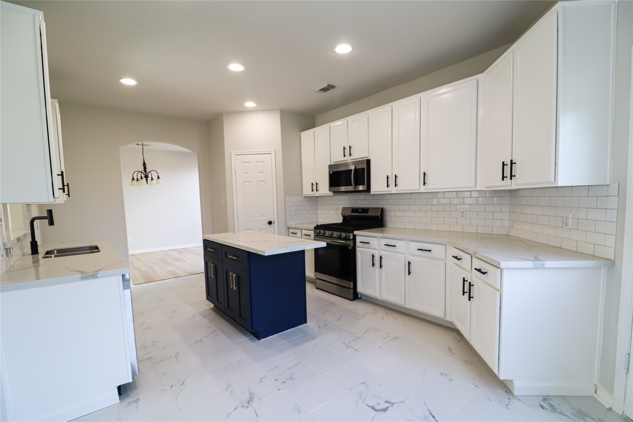 4106 Forest Rain Lane Atascocita, TX 77346 - Photo 22 of 49 a large kitchen with stainless steel appliances granite countertop a stove a sink a refrigerator and a granite counter tops