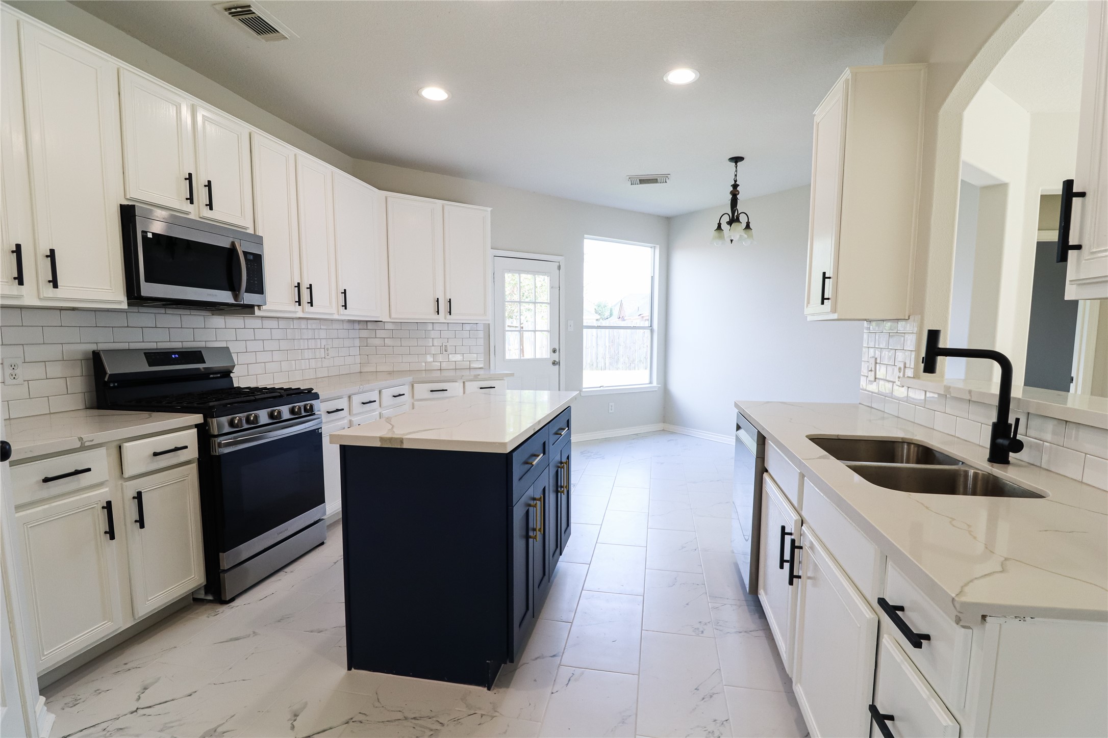 4106 Forest Rain Lane Atascocita, TX 77346 - Photo 24 of 49 a kitchen with a sink stove and microwave