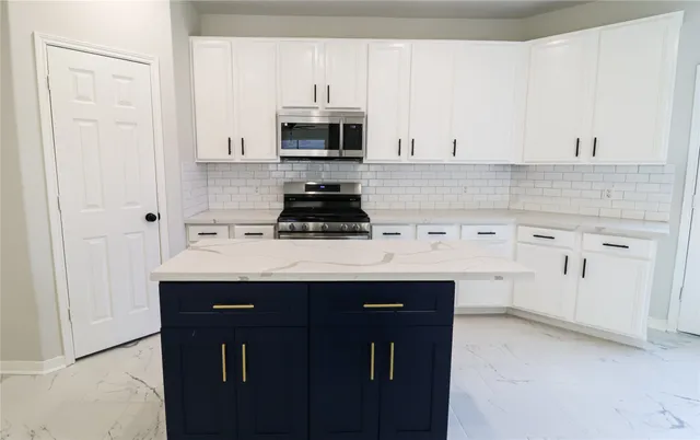 a kitchen with white cabinets sink and white appliances