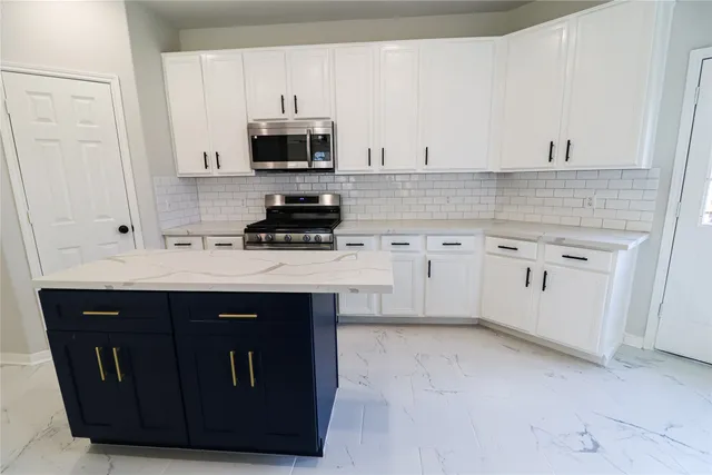 a kitchen with a sink stove and microwave