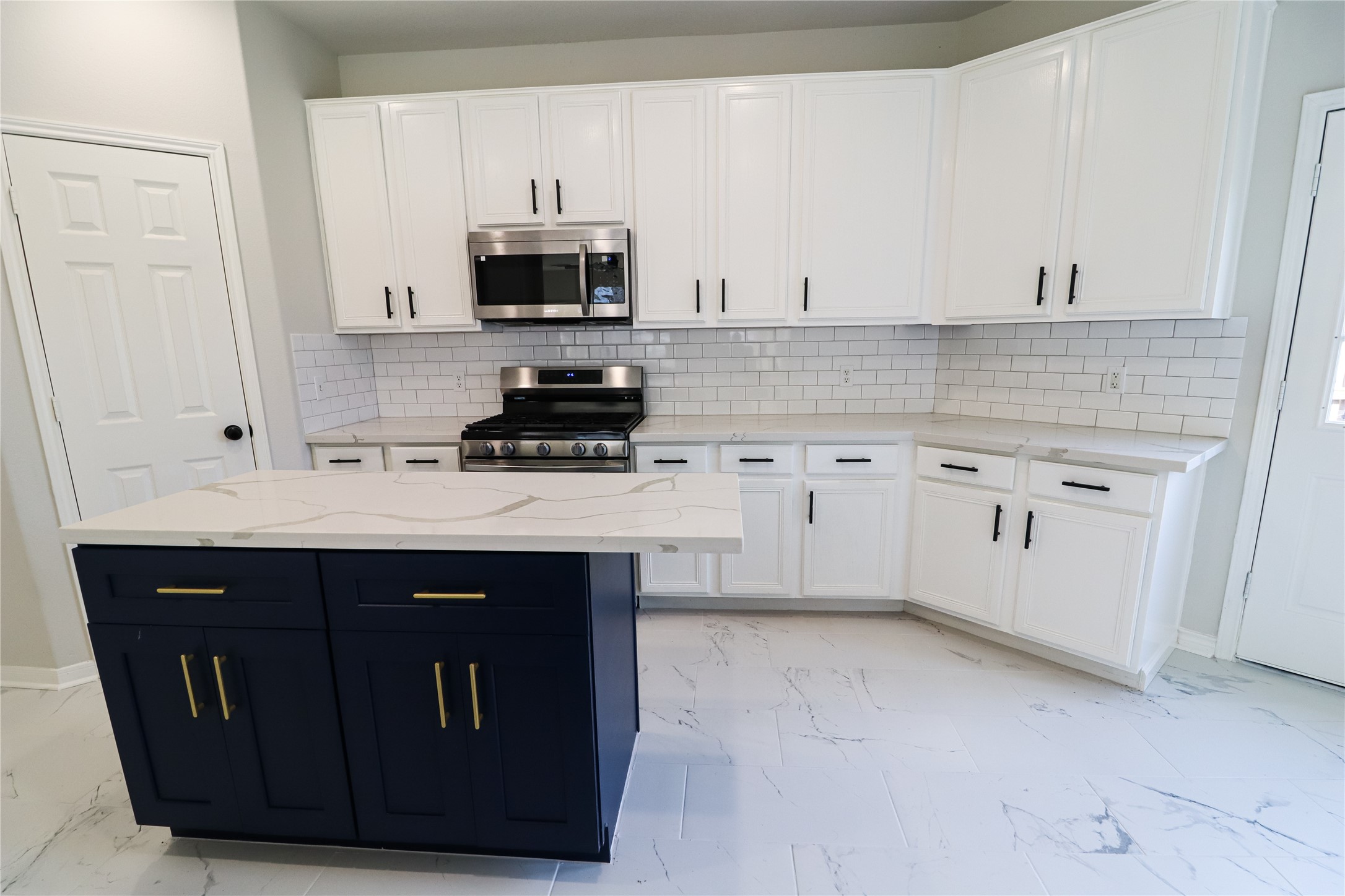 4106 Forest Rain Lane Atascocita, TX 77346 - Photo 26 of 49 a kitchen with a sink stove and microwave