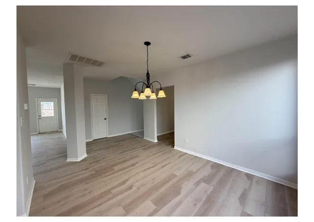 a view of a room with wooden floor