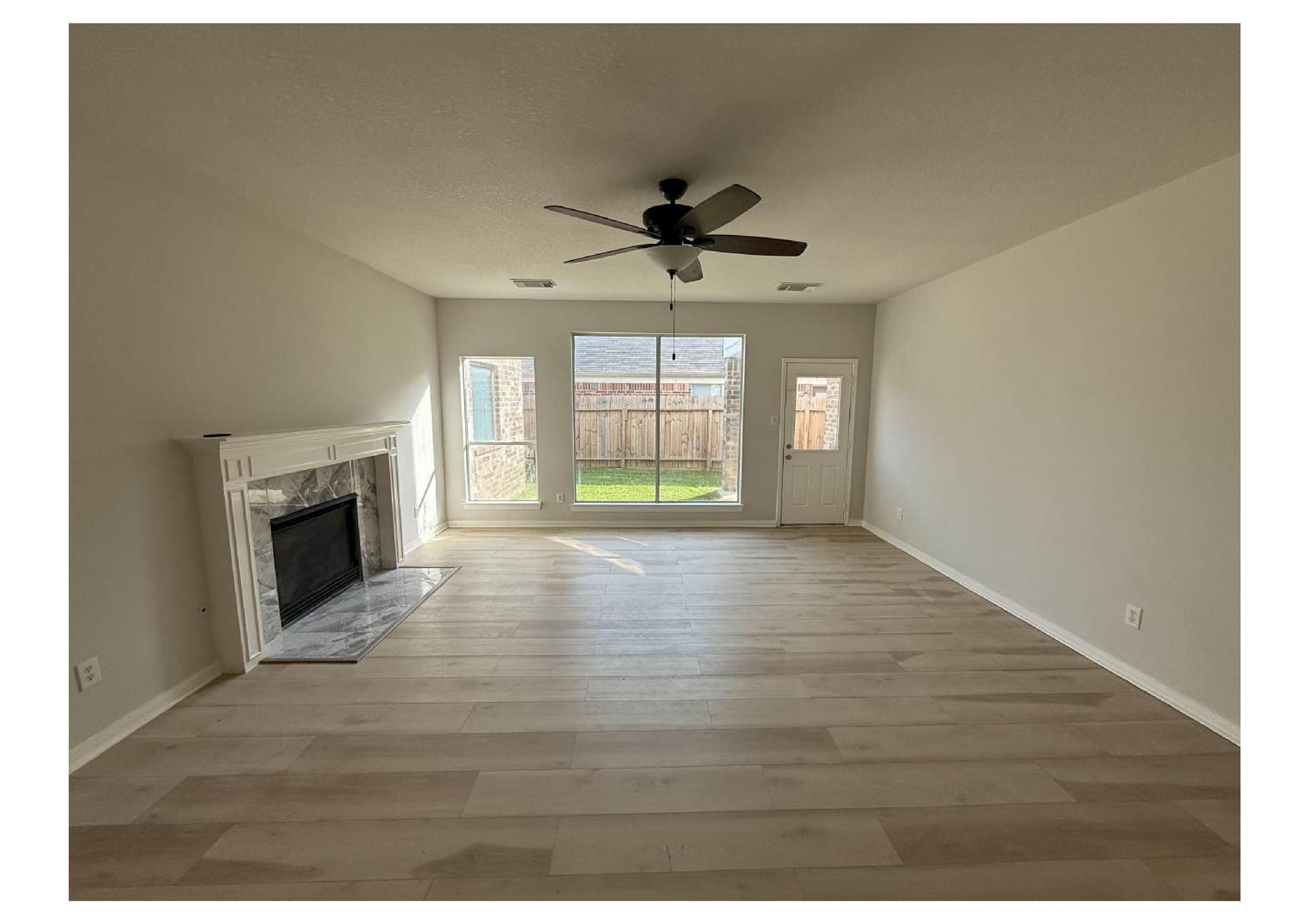 4106 Forest Rain Lane Atascocita, TX 77346 - Photo 31 of 49 a view of an empty room with a fireplace and a window