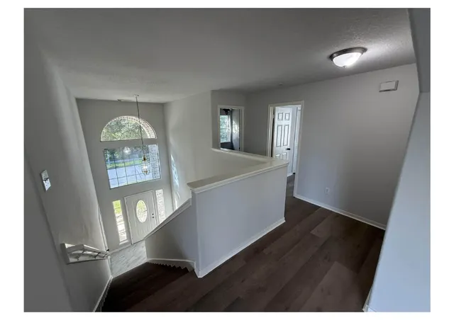a view of an entryway with wooden floor