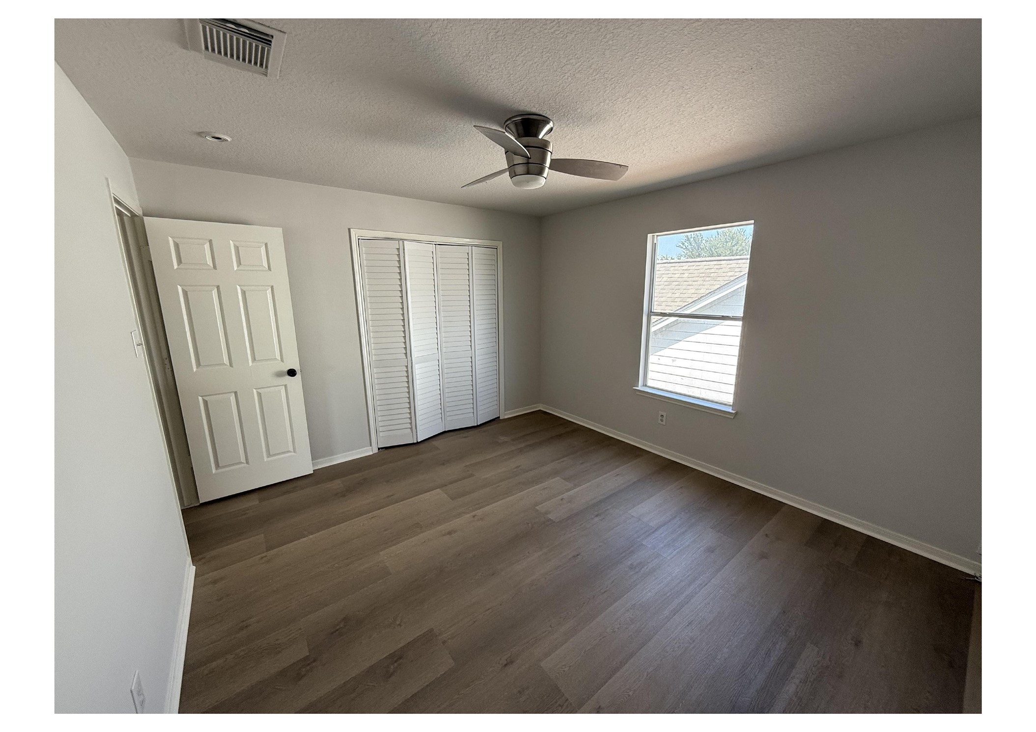 4106 Forest Rain Lane Atascocita, TX 77346 - Photo 45 of 49 an empty room with wooden floor and windows