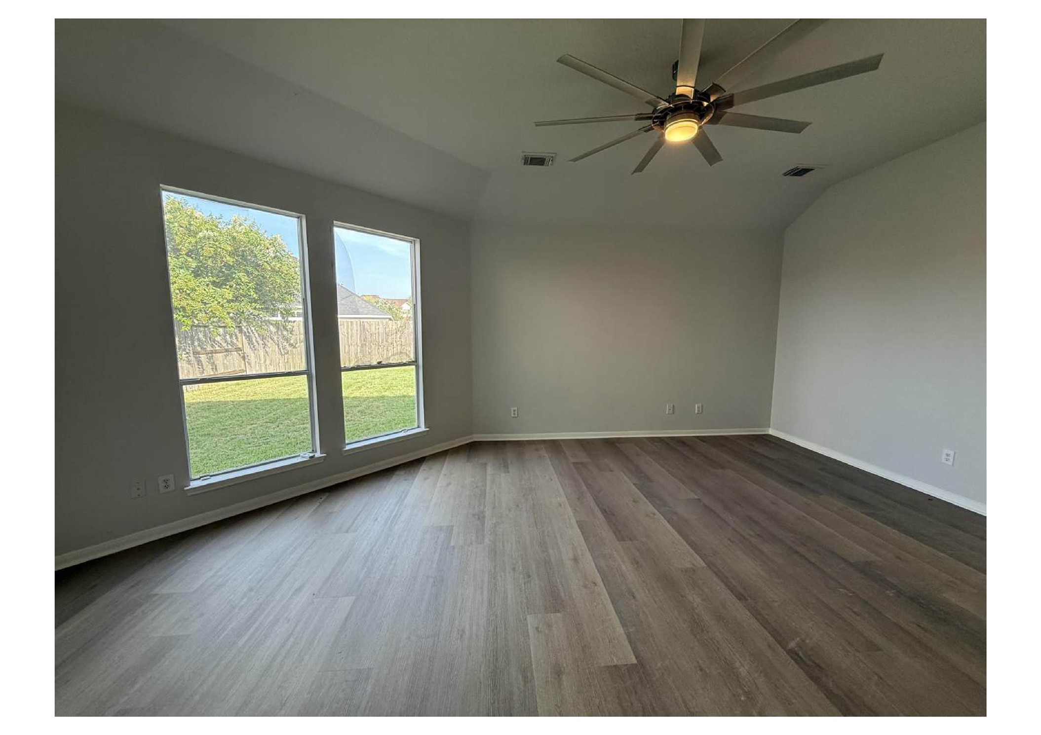 4106 Forest Rain Lane Atascocita, TX 77346 - Photo 5 of 49 an empty room with wooden floor and windows