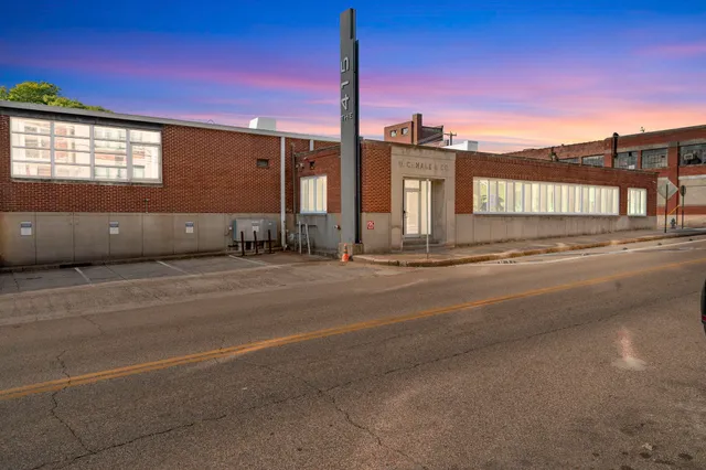 a view of a street with a building in the background
