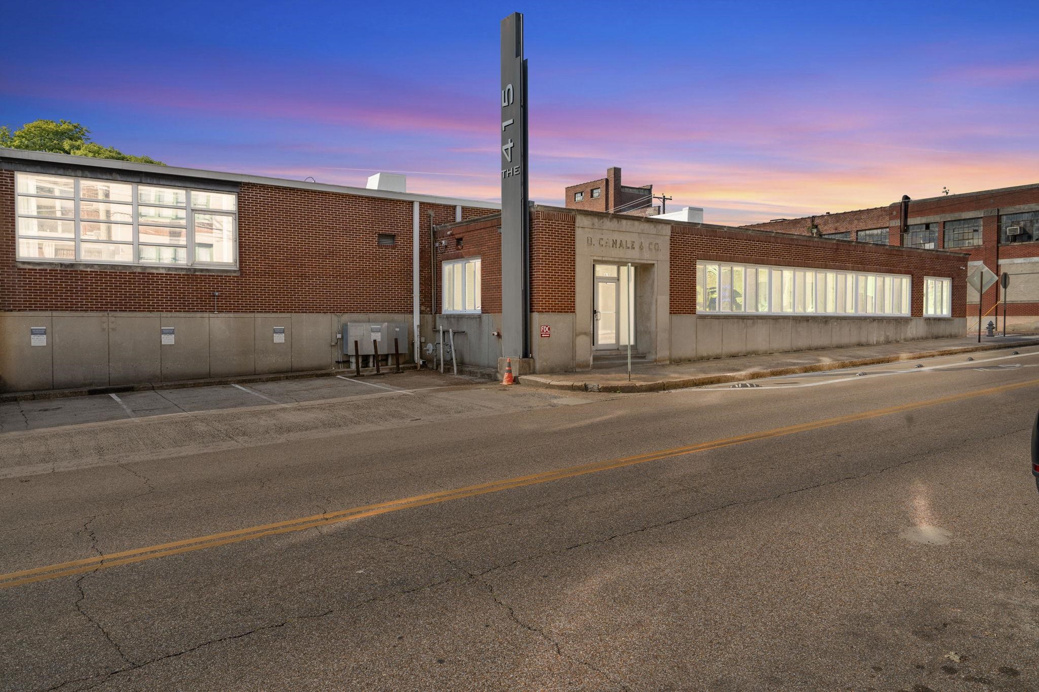 a view of a street with a building in the background