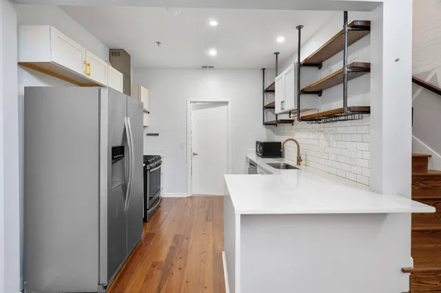a kitchen with stainless steel appliances a refrigerator and a sink
