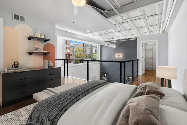 a bed room with a bed and a large mirror