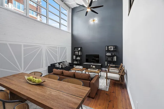 a living room with furniture and a wooden floor
