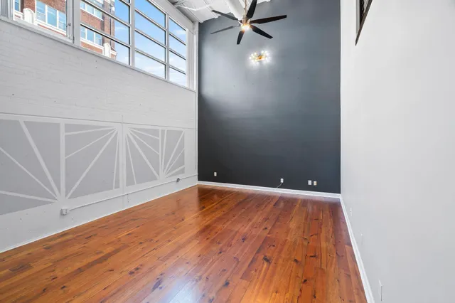 a view of an empty room with wooden floor