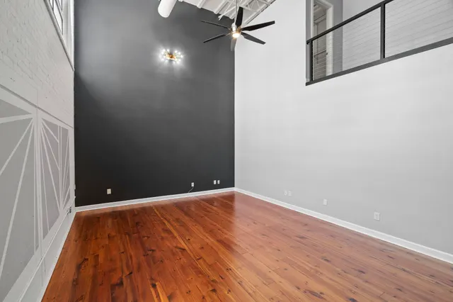 a view of a room with wooden floor and small entryway
