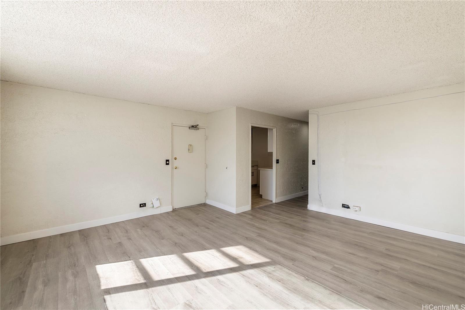 98-1030 Moanalua Road, Unit 5204 Aiea, HI 96701 - Photo 2 of 16 an empty room with wooden floor