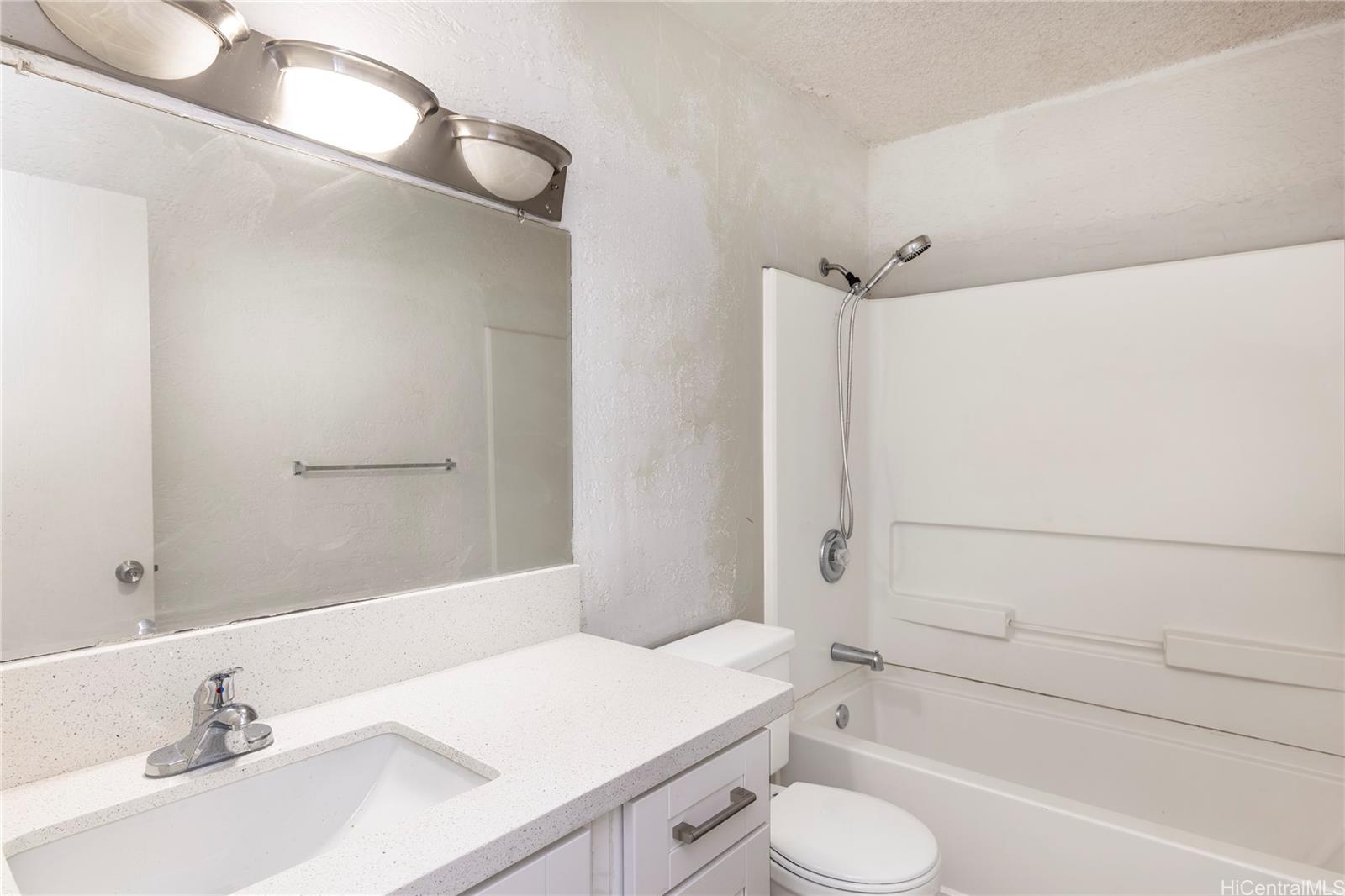 98-1030 Moanalua Road, Unit 5204 Aiea, HI 96701 - Photo 5 of 16 a bathroom with a sink toilet and shower