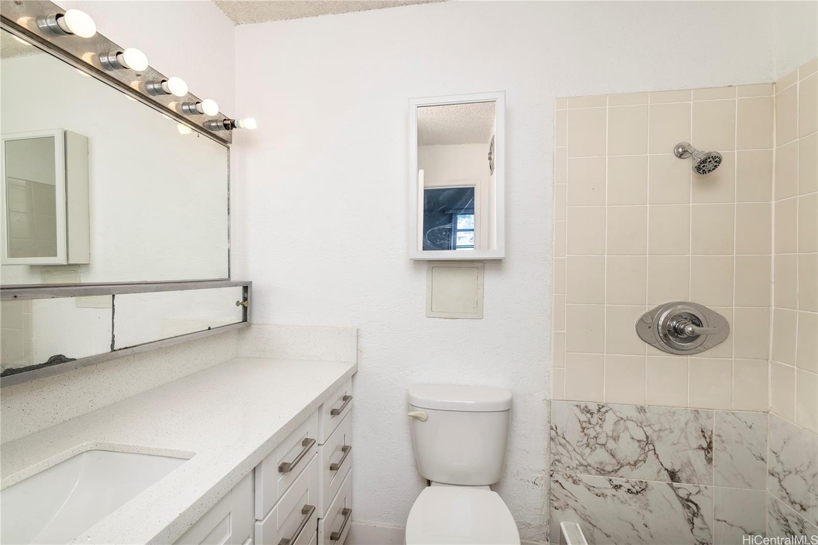 98-1030 Moanalua Road, Unit 5204 Aiea, HI 96701 - Photo 9 of 16 a bathroom with a toilet sink and shower