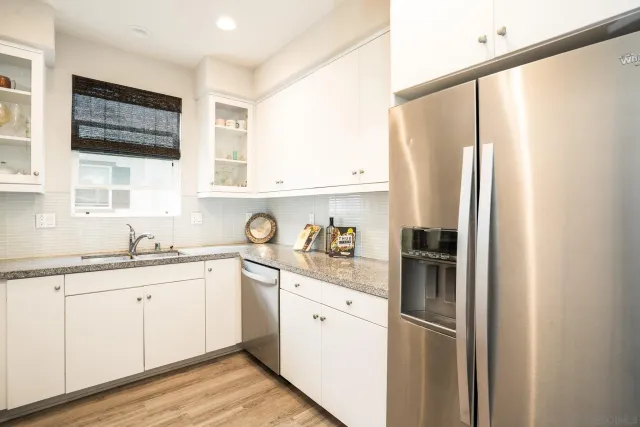 a kitchen with stainless steel appliances a refrigerator sink and cabinets
