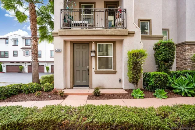 front view of a brick house with a yard