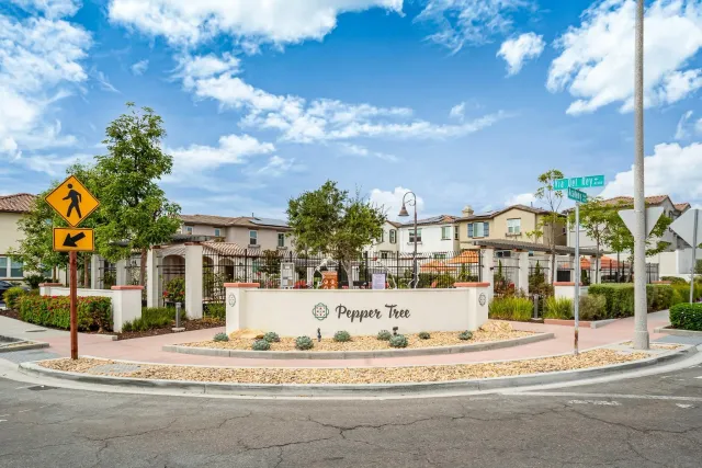 a view of a white house with a street