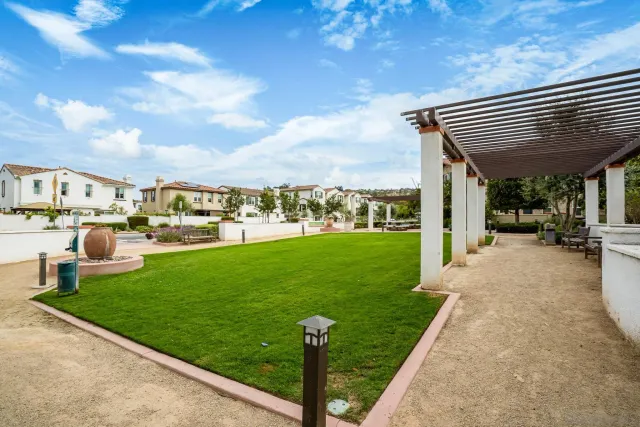 a view of a patio with table and chairs and garden