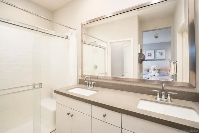 a bathroom with a double vanity sink mirror and double