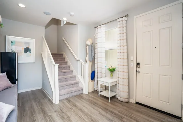 a view of a livingroom with wooden floor and entryway