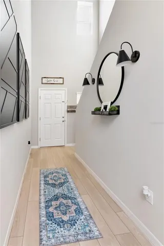 a living room with furniture and a dining table with kitchen view