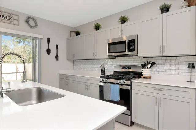 a kitchen with a sink stove and refrigerator