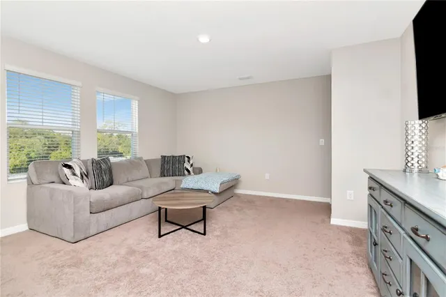 a view of room with furniture and flat screen tv