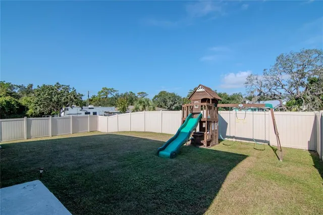 a view of swimming pool with a lounge chairs