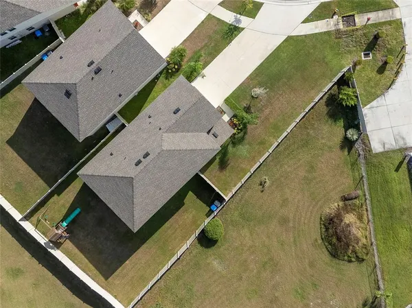 an aerial view of a house with a backyard