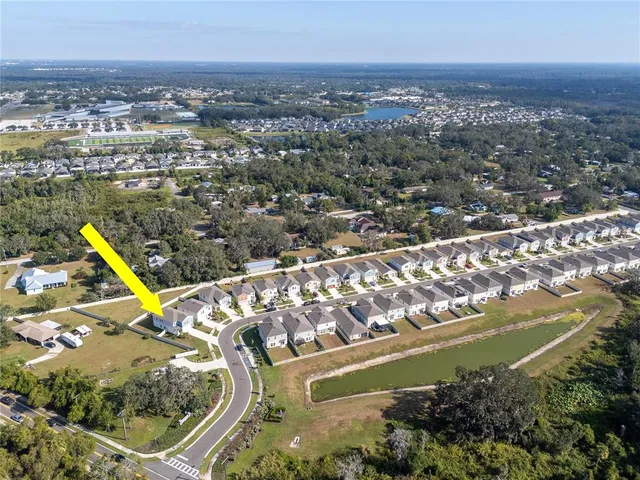 an aerial view of residential houses with yard