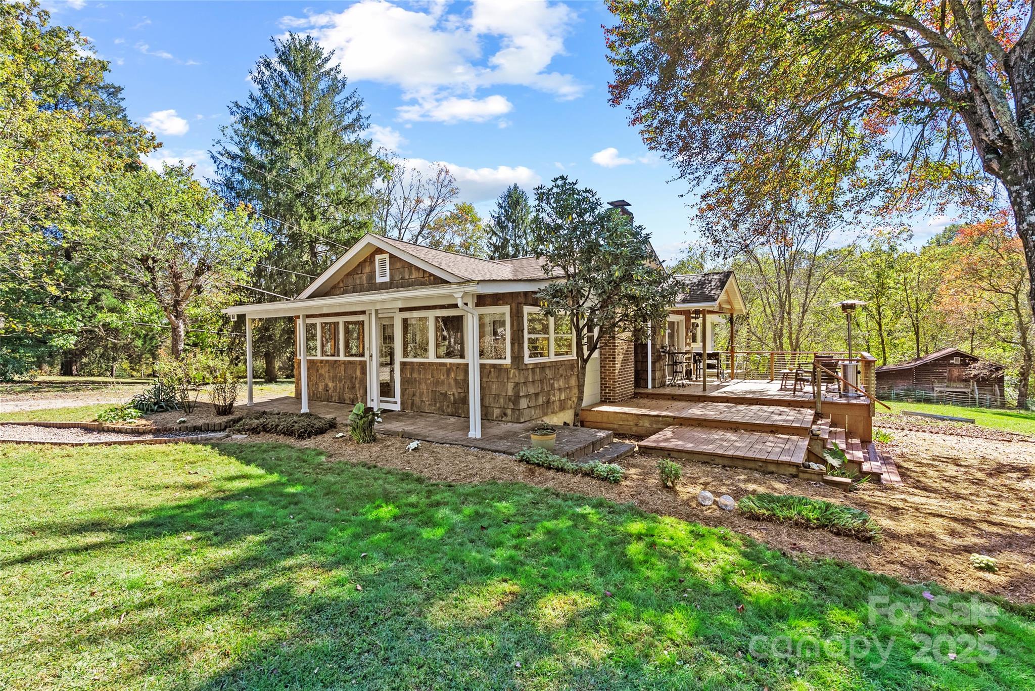 a front view of a house with patio and garden