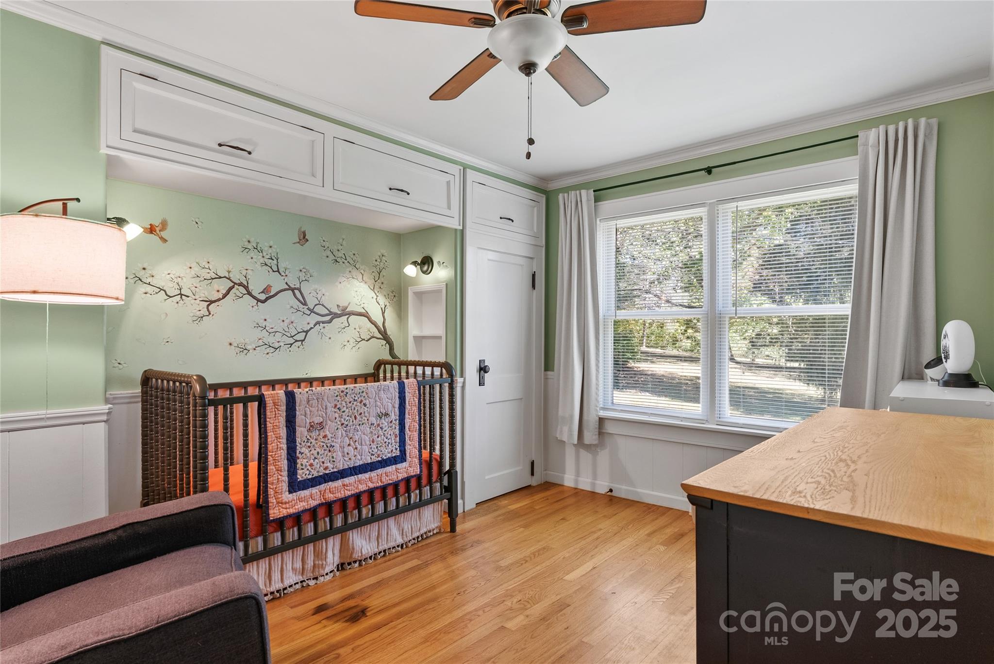 175 Candler School Road Candler, NC 28715 - Photo 12 of 37 a view of a bedroom with wooden floor and a ceiling fan