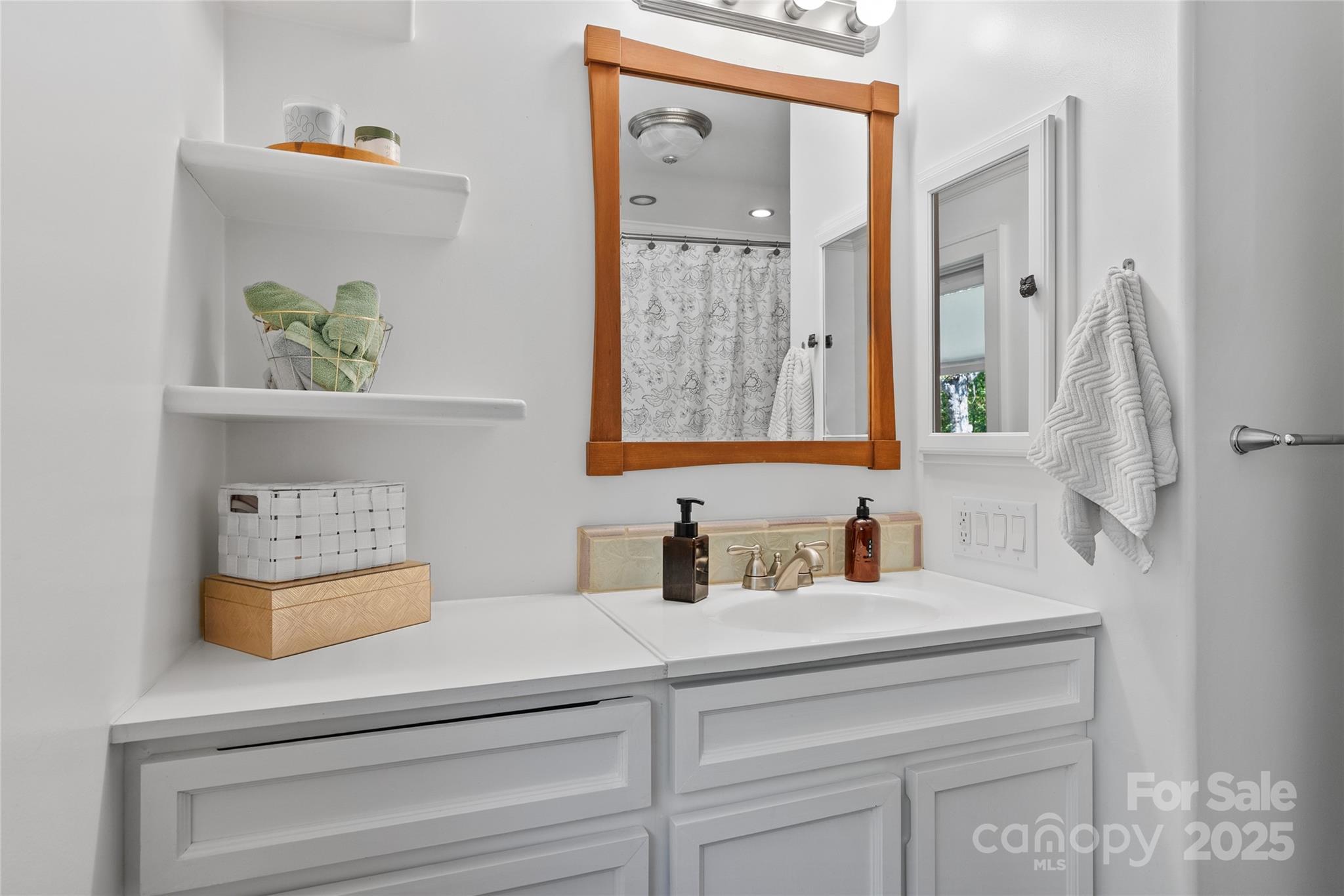 175 Candler School Road Candler, NC 28715 - Photo 14 of 37 a bathroom with a sink and a mirror
