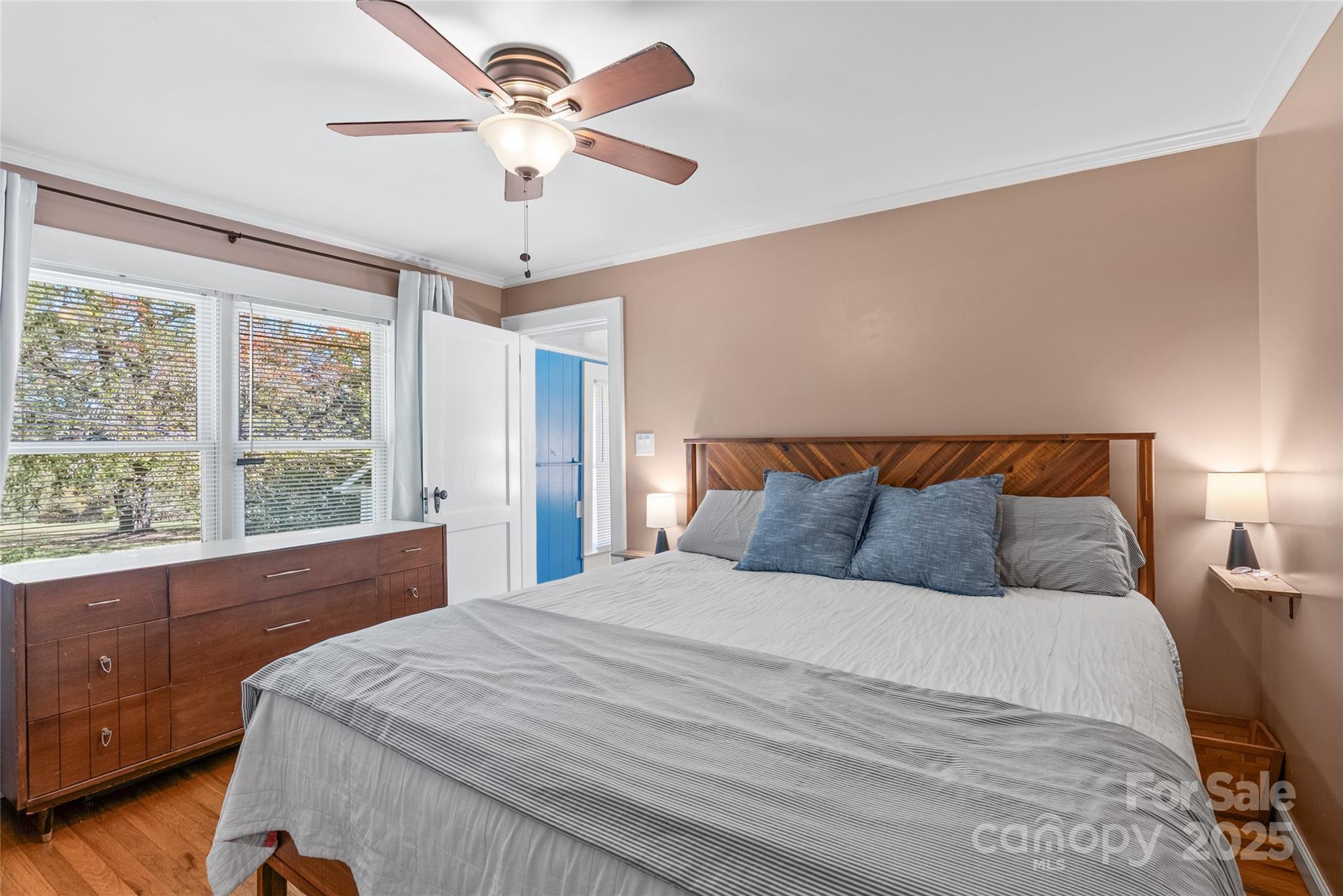 175 Candler School Road Candler, NC 28715 - Photo 17 of 37 a bedroom with a large bed and a chandelier