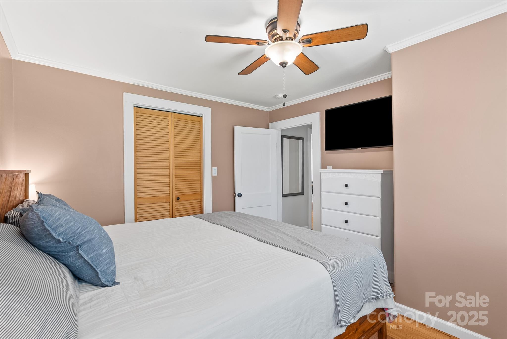 175 Candler School Road Candler, NC 28715 - Photo 19 of 37 a bedroom with a large bed and a flat tv screen
