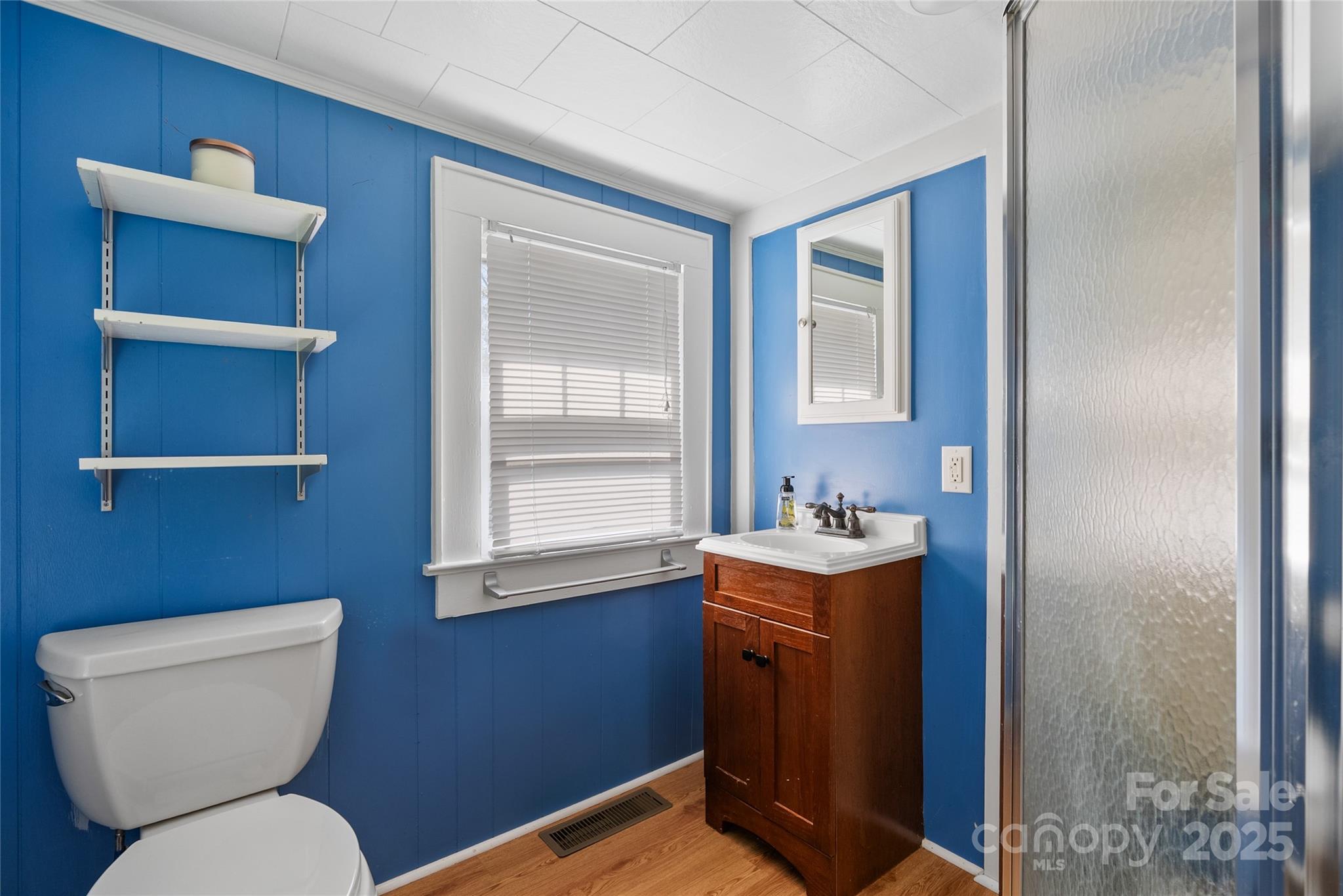 175 Candler School Road Candler, NC 28715 - Photo 20 of 37 a bathroom with a toilet sink and mirror