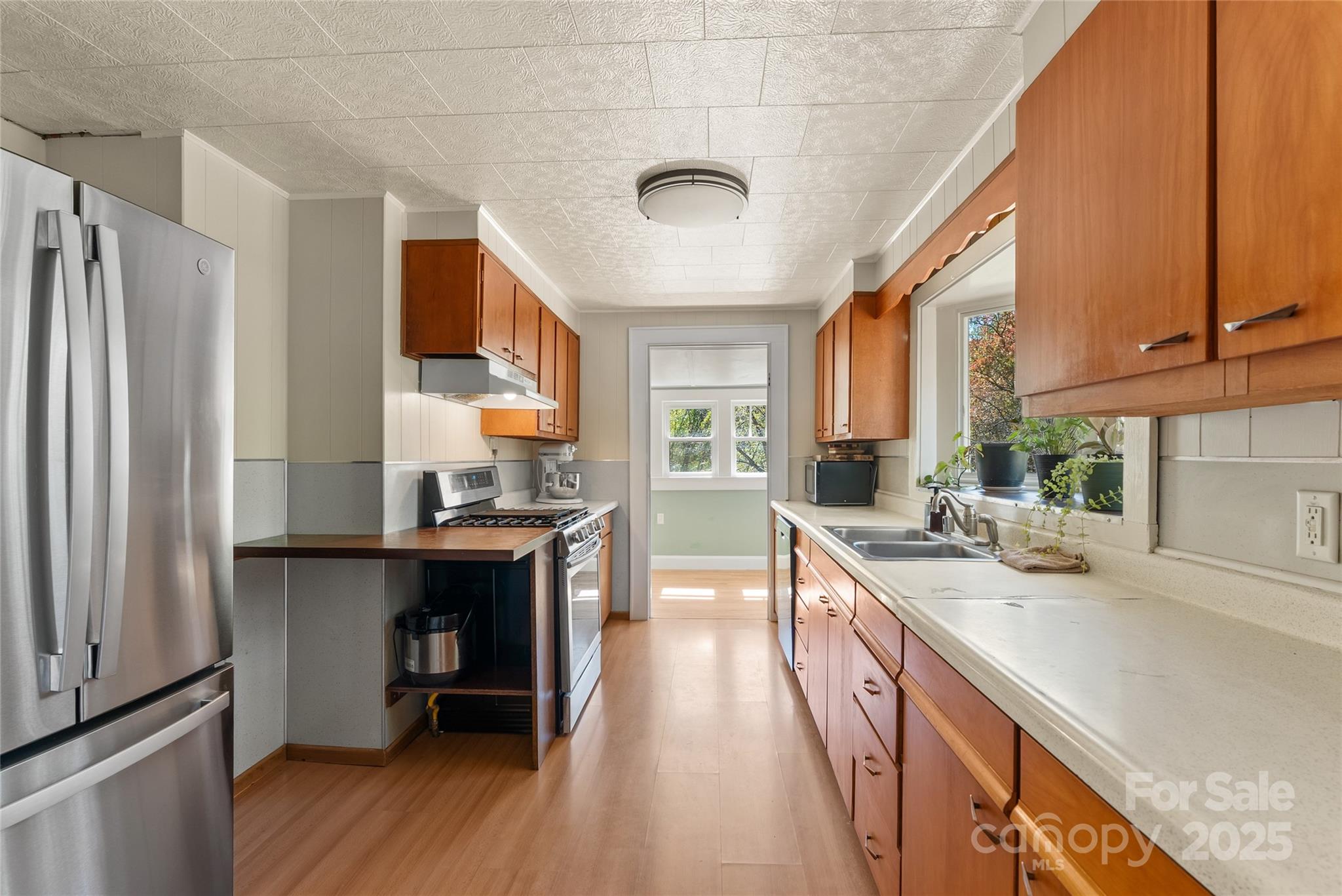 175 Candler School Road Candler, NC 28715 - Photo 23 of 37 a kitchen with stainless steel appliances a sink a stove and a refrigerator