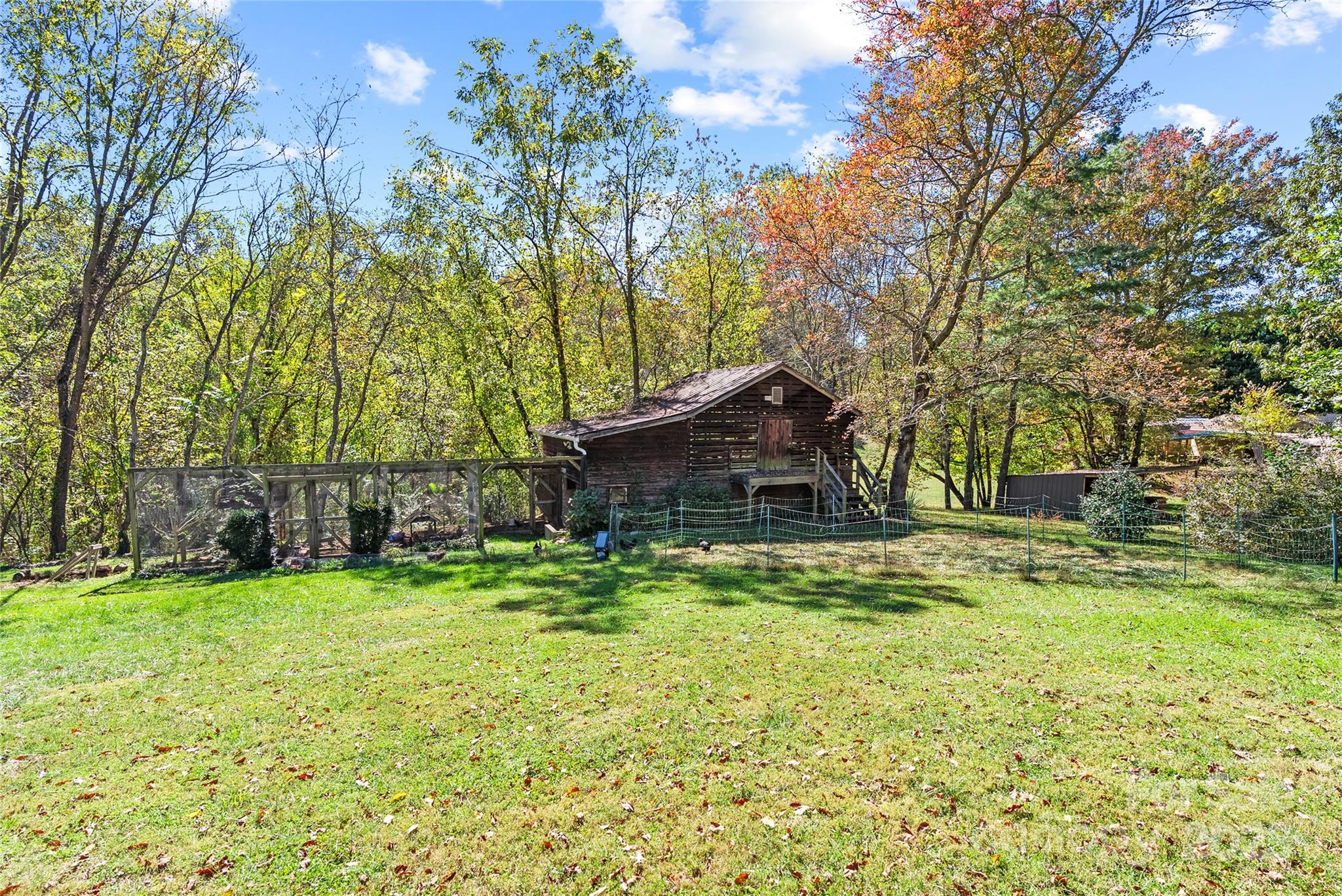 175 Candler School Road Candler, NC 28715 - Photo 3 of 37 a backyard of a house with table and chairs