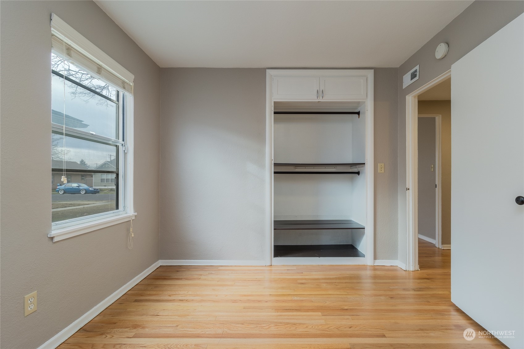 1055 St John Walla Walla, WA 99362 - Photo 14 of 27 a view of an empty room with a window and wooden floor