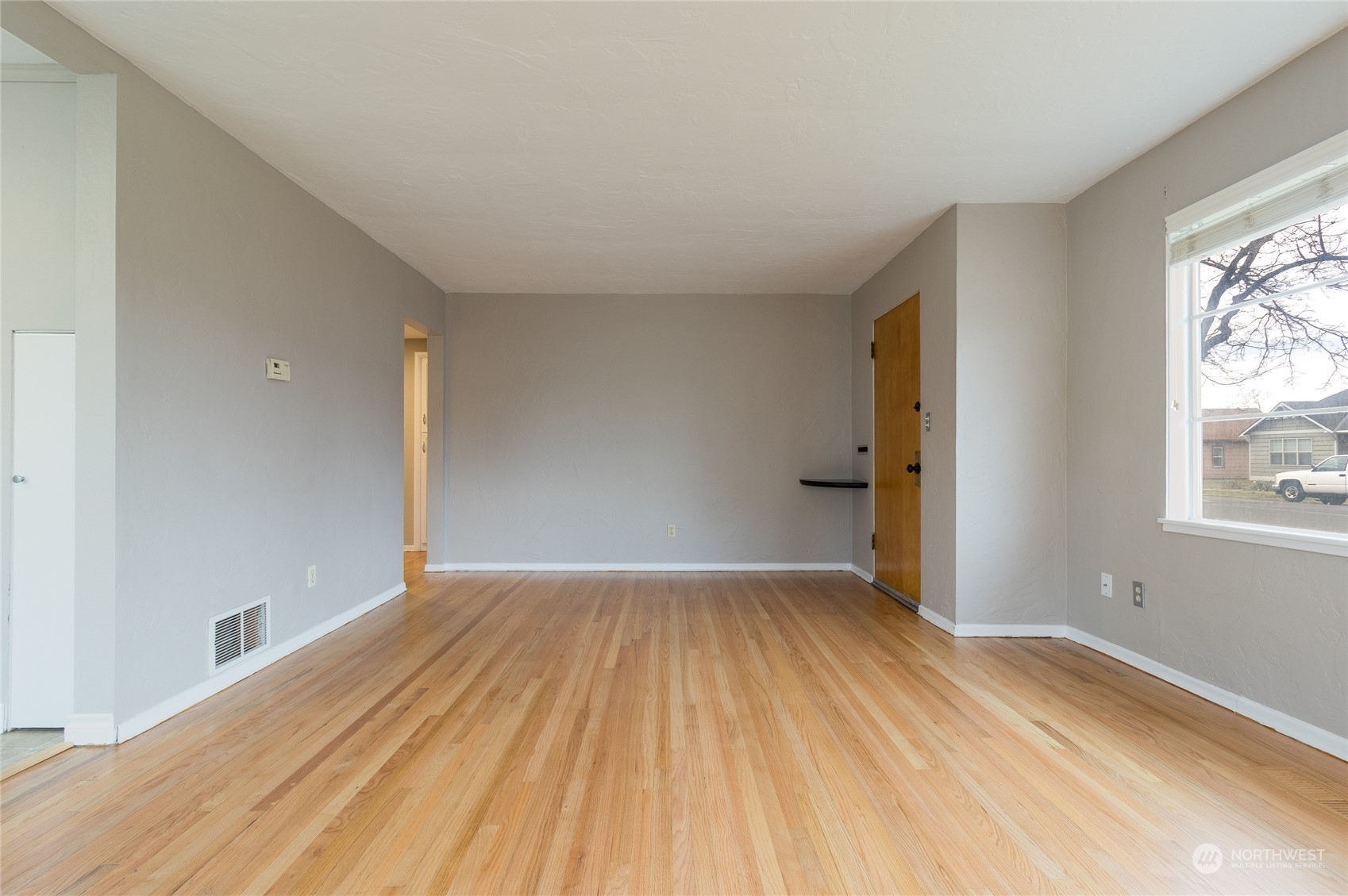 1055 St John Walla Walla, WA 99362 - Photo 9 of 27 wooden floor in an empty room with a window