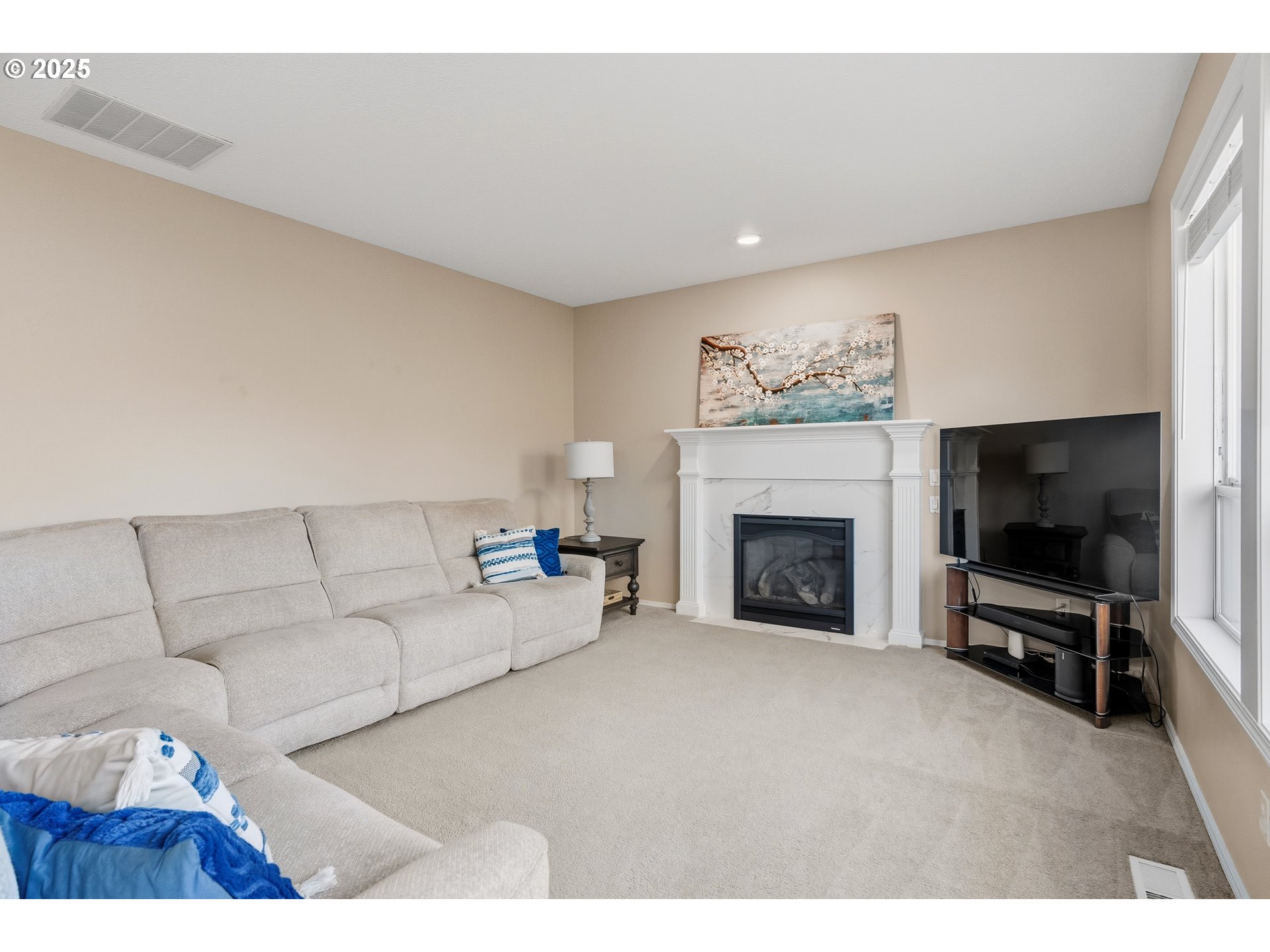 20194 Canyon Ridge Drive Oregon City, OR 97045 - Photo 12 of 41 a living room with furniture a flat screen tv and a fireplace