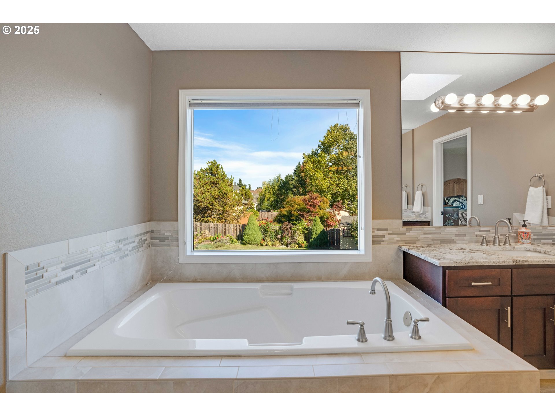 20194 Canyon Ridge Drive Oregon City, OR 97045 - Photo 17 of 41 a white bath tub sitting in a bathroom next to a window