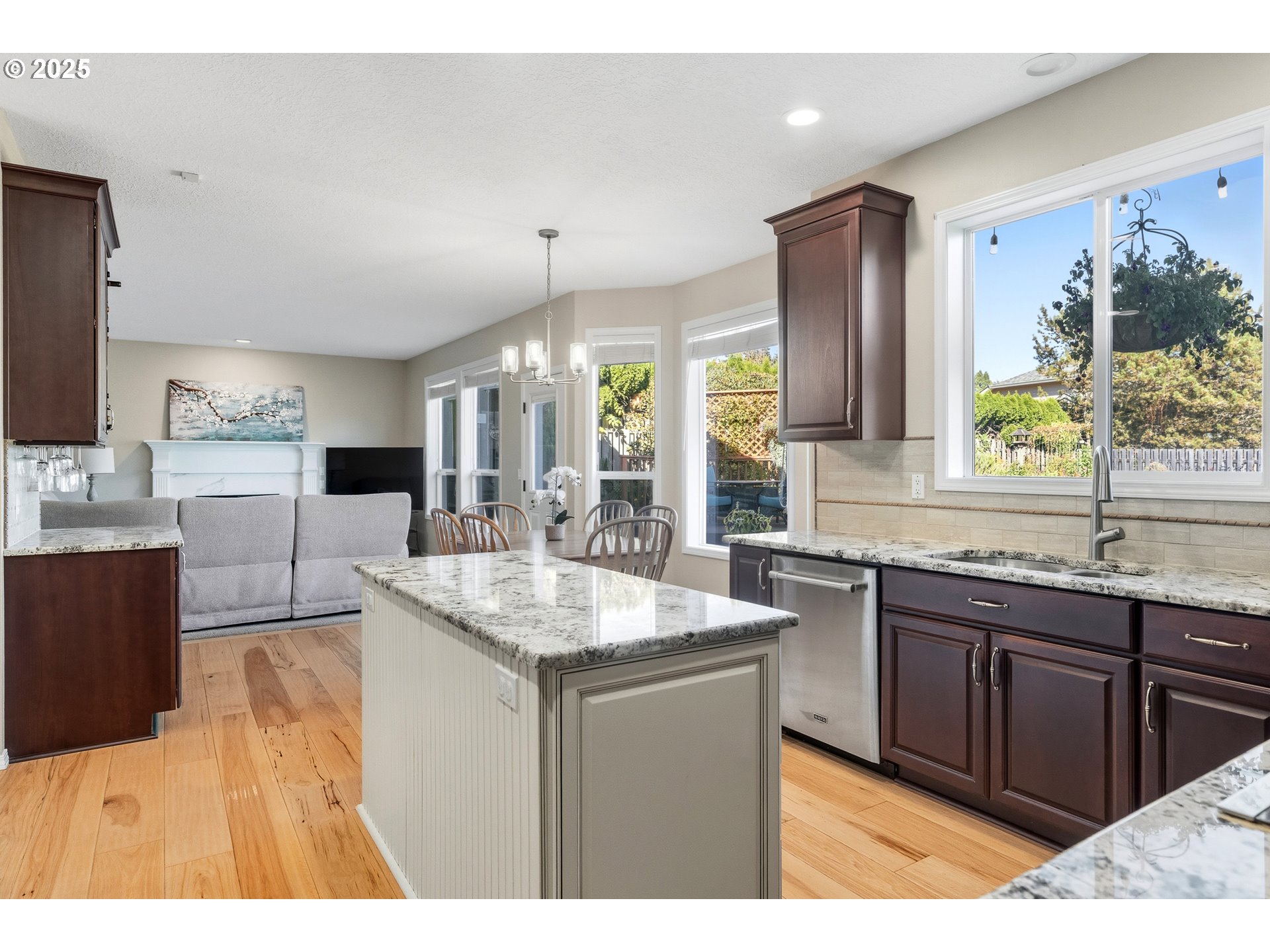 20194 Canyon Ridge Drive Oregon City, OR 97045 - Photo 7 of 41 a kitchen with granite countertop a sink and a wooden cabinets